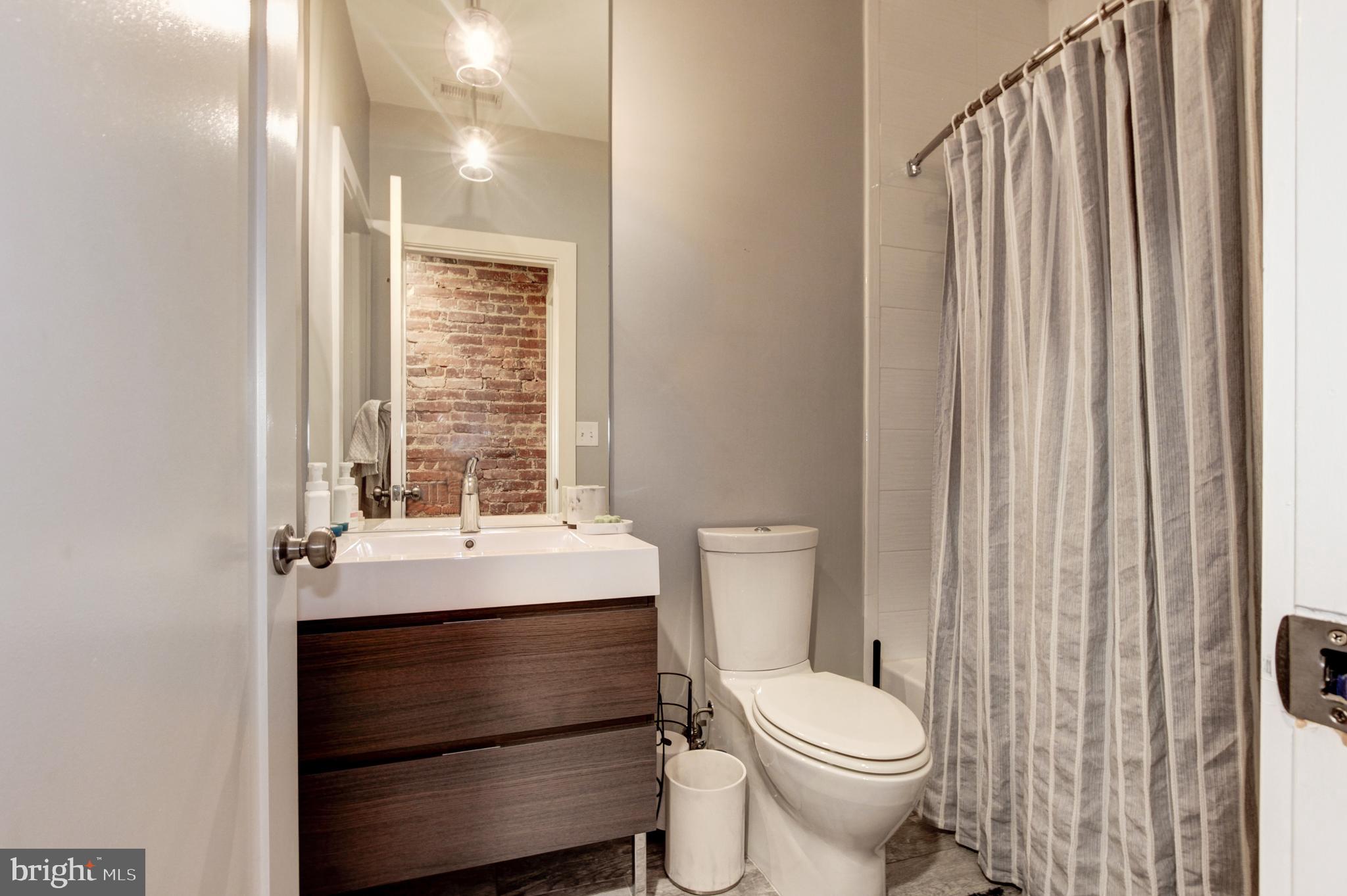 37 Todd Place Northeast, Unit 3 Washington, DC 20002 - Photo 19 of 28 a bathroom with a sink toilet and window