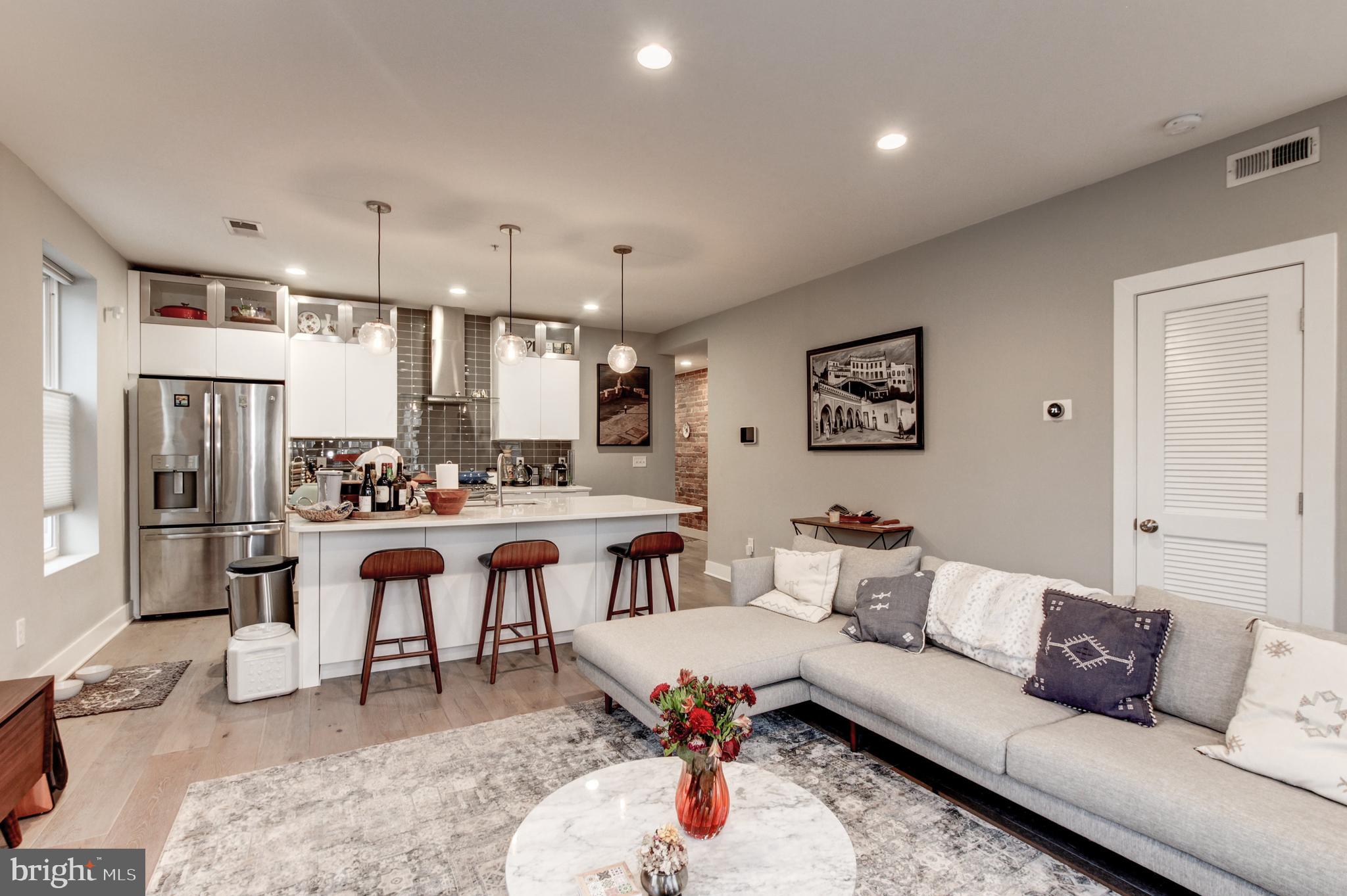 37 Todd Place Northeast, Unit 3 Washington, DC 20002 - Photo 4 of 28 a living room with furniture kitchen view and a refrigerator