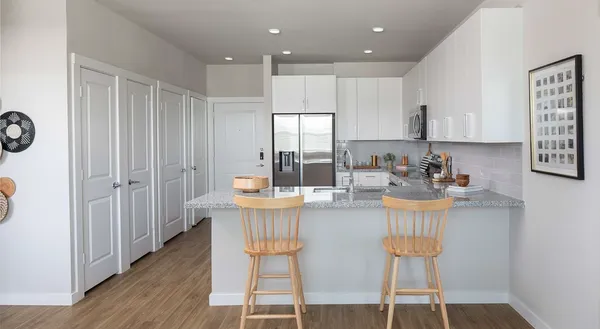 a dining table chairs and a kitchen view