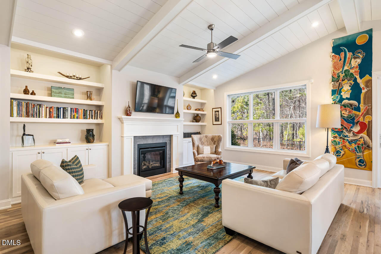 45 Post Oak Road Chapel Hill, NC 27516 - Photo 18 of 89 a living room with furniture a flat screen tv and a fireplace