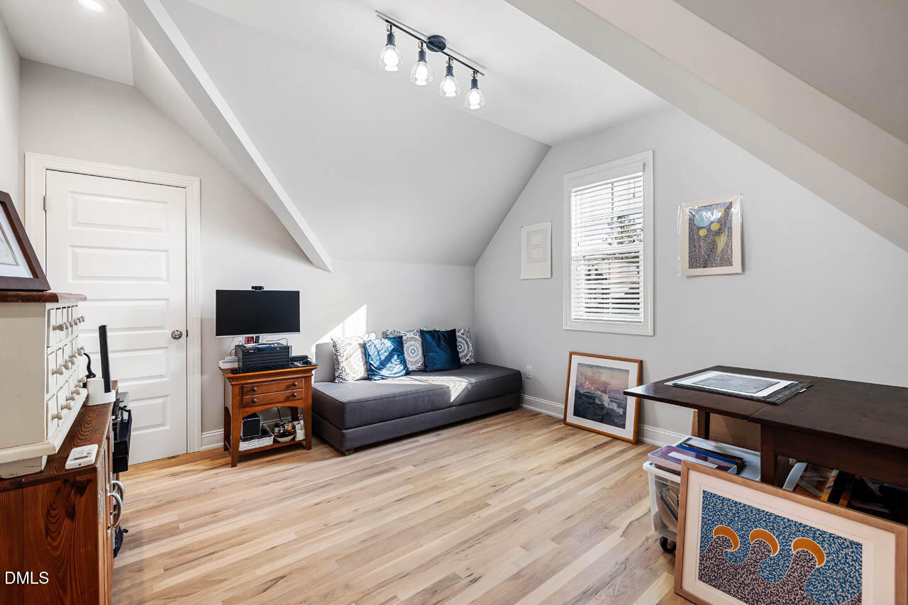 45 Post Oak Road Chapel Hill, NC 27516 - Photo 36 of 89 a living room with furniture a flat screen tv and gym equipment