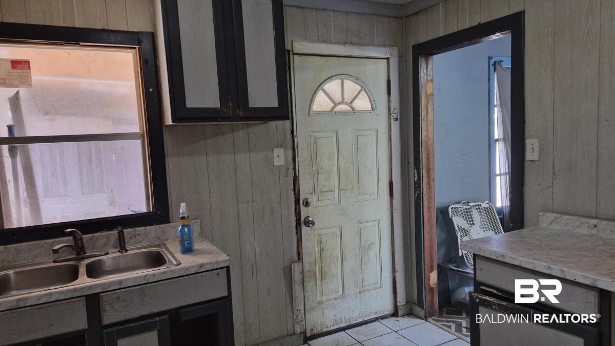 2207 Roberta Drive Mobile, AL 36617 - Photo 8 of 14 Entryway with wood walls and tile patterned flooring