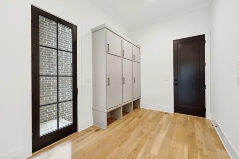 a bathroom with a double vanity sink toilet and mirror