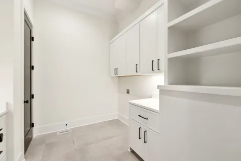 a view of walk in closet with empty racks
