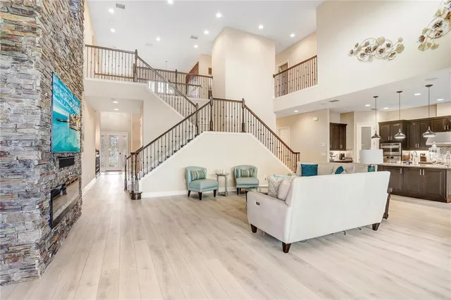 a kitchen with stainless steel appliances kitchen island granite countertop a sink refrigerator and cabinets