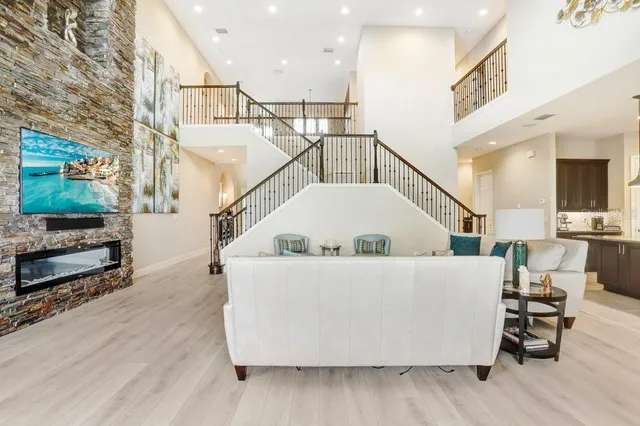 a kitchen with stainless steel appliances granite countertop a sink a stove and a refrigerator