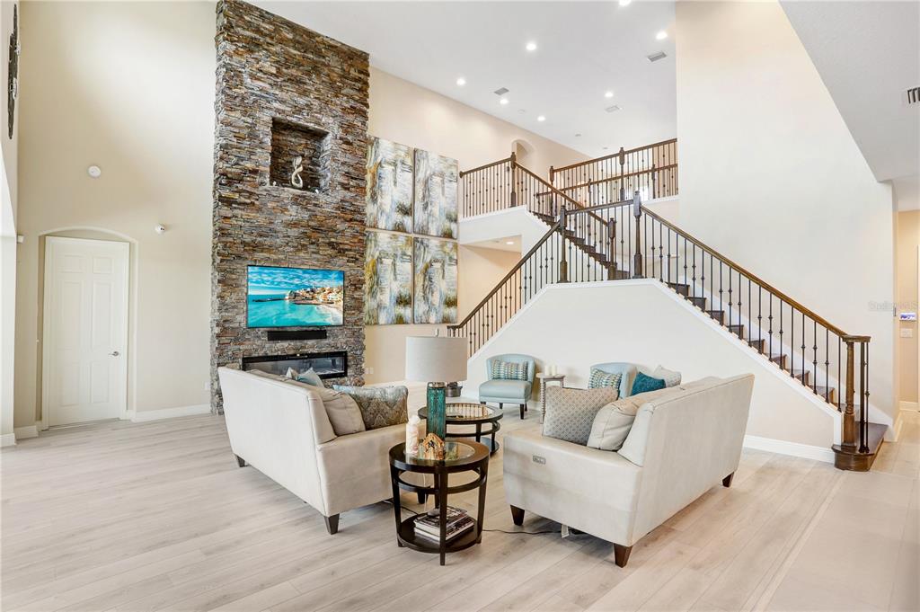 32450 Talimena Loop Wesley Chapel, FL 33543 - Photo 17 of 68 a living room with furniture and stairs