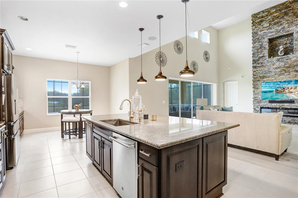 32450 Talimena Loop Wesley Chapel, FL 33543 - Photo 20 of 68 a open kitchen with stainless steel appliances granite countertop a sink a stove and a refrigerator