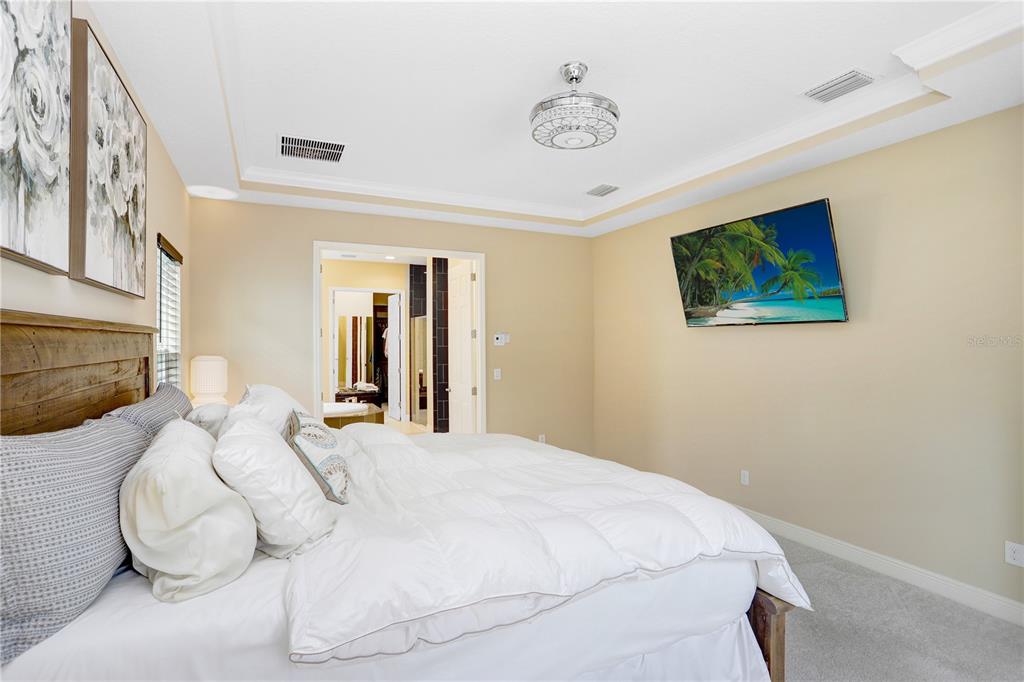 32450 Talimena Loop Wesley Chapel, FL 33543 - Photo 23 of 68 a bedroom with a bed and a painting on the wall