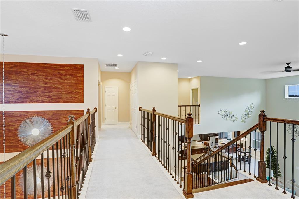 32450 Talimena Loop Wesley Chapel, FL 33543 - Photo 30 of 68 a view of a hallway with wooden floor stairs
