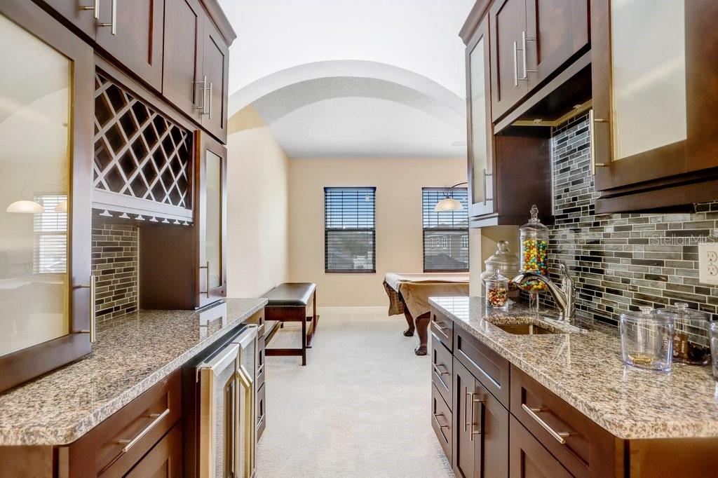 32450 Talimena Loop Wesley Chapel, FL 33543 - Photo 32 of 68 a kitchen with stainless steel appliances granite countertop a sink and stove