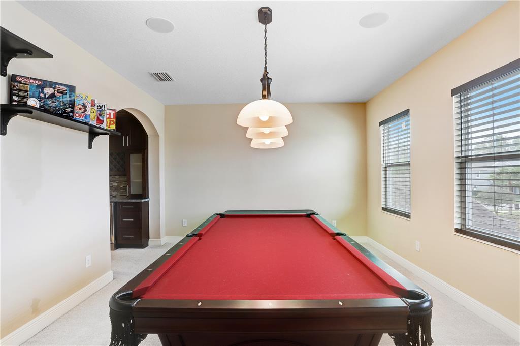 32450 Talimena Loop Wesley Chapel, FL 33543 - Photo 33 of 68 a room with pool table and windows