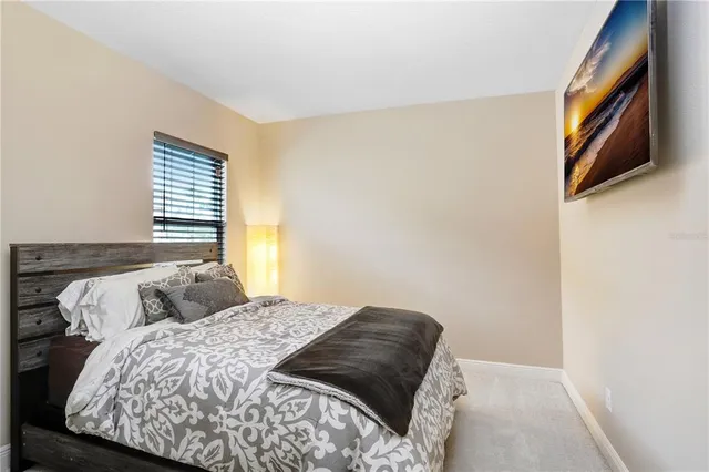 a living room with furniture a flat screen tv and a floor to ceiling window