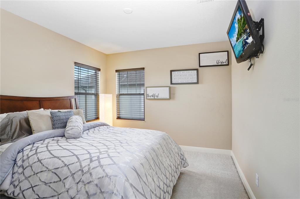 32450 Talimena Loop Wesley Chapel, FL 33543 - Photo 37 of 68 a bedroom with a bed and painting on the wall