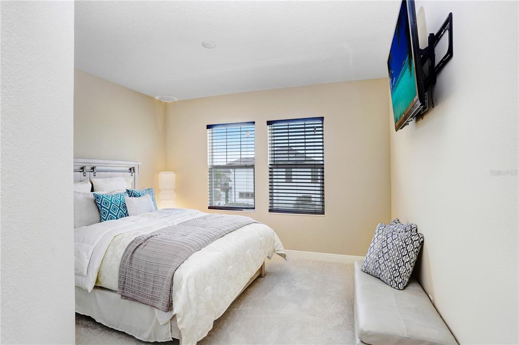 32450 Talimena Loop Wesley Chapel, FL 33543 - Photo 38 of 68 a bedroom with a bed television and a window