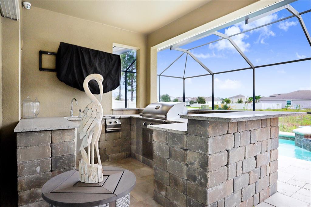 32450 Talimena Loop Wesley Chapel, FL 33543 - Photo 41 of 68 a kitchen with a sink a counter space and a stove