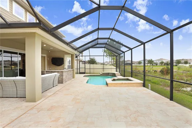 an aerial view of a house with a swimming pool
