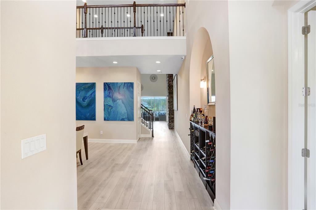 32450 Talimena Loop Wesley Chapel, FL 33543 - Photo 5 of 68 a view of a hallway with wooden floor and staircase