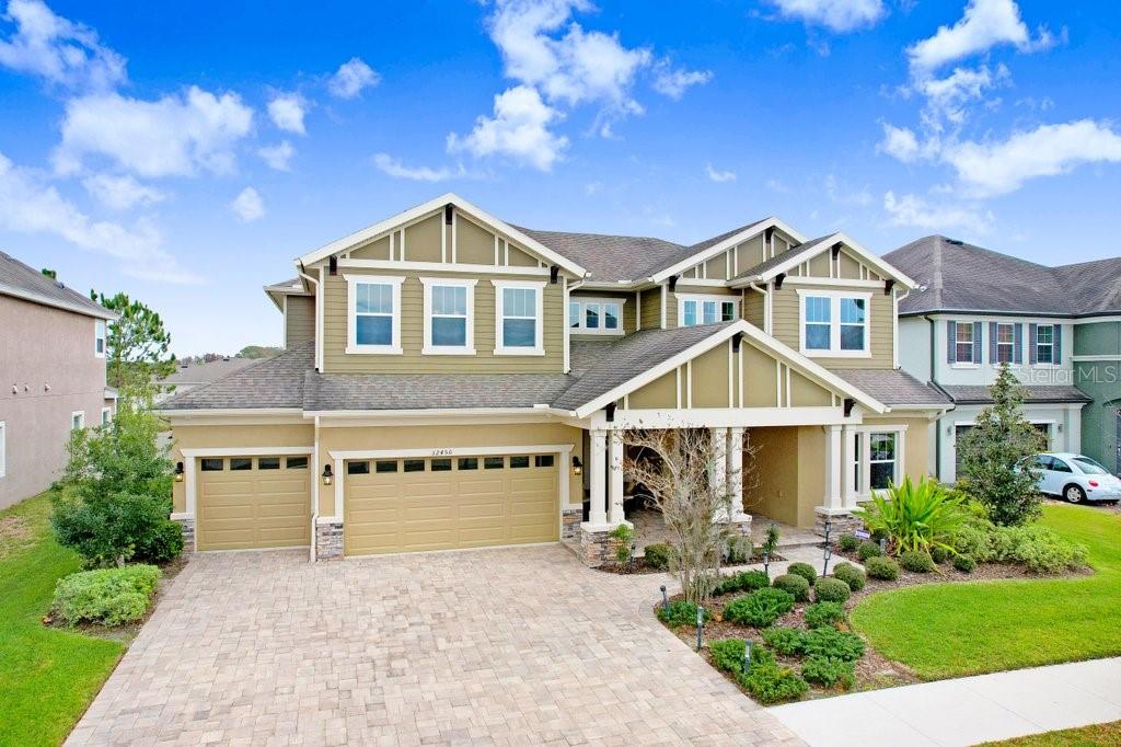 32450 Talimena Loop Wesley Chapel, FL 33543 - Photo 67 of 68 a front view of a house with a yard and garage