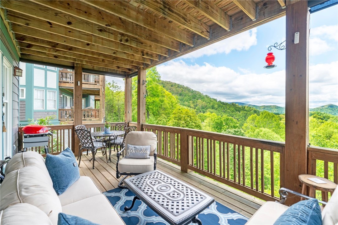 942 Ridge Haven Parkway, Unit R1211 Banner Elk, NC 28604 - Photo 15 of 45 a outdoor living space with furniture and garden view