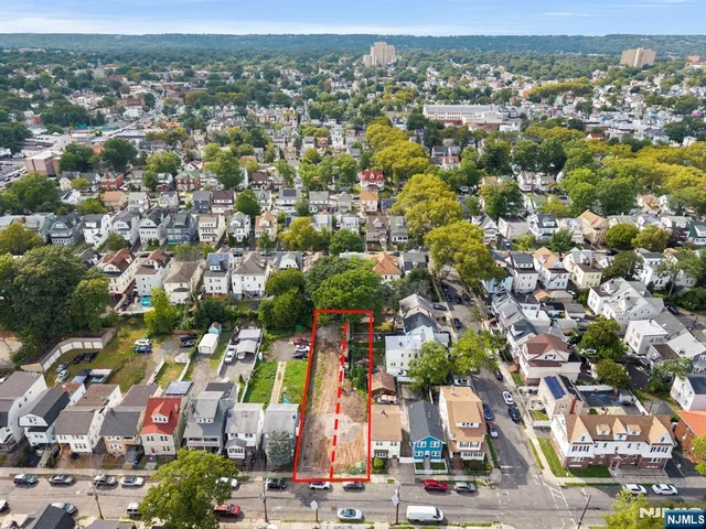 an aerial view of residential houses with outdoor space and street view