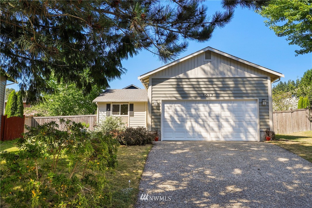 1017 234th Place Southwest Bothell, WA 98021 - Photo 1 of 28 a front view of a house with a yard
