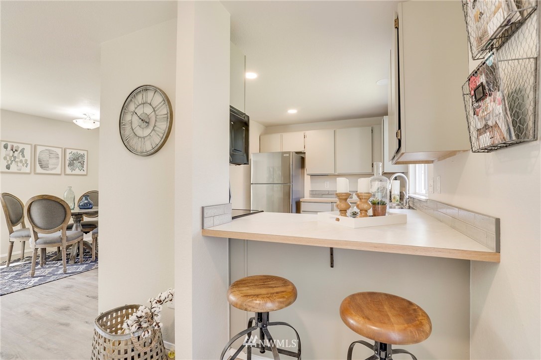 1017 234th Place Southwest Bothell, WA 98021 - Photo 11 of 28 a kitchen with a dining table and chairs