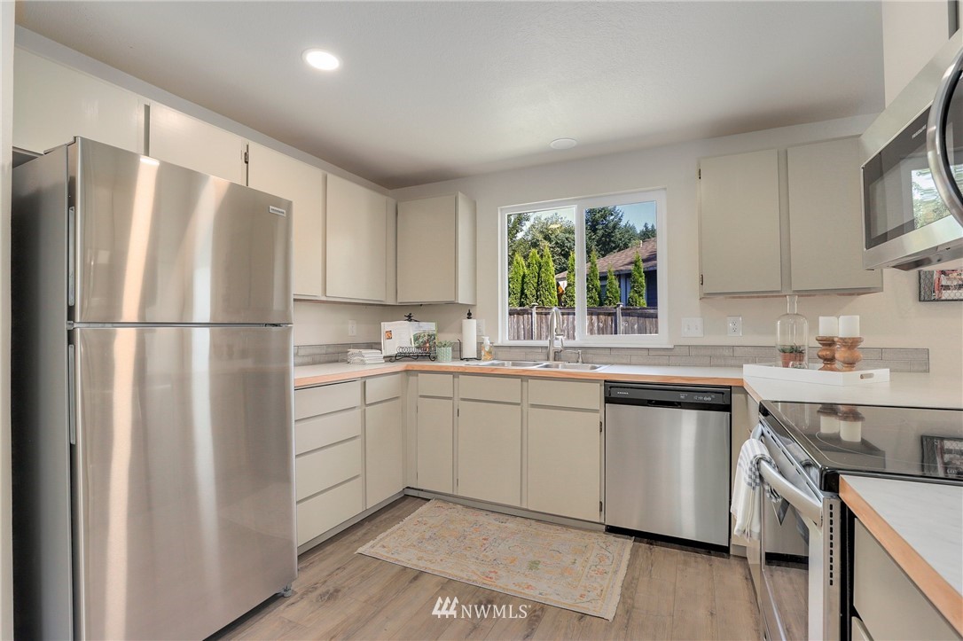 1017 234th Place Southwest Bothell, WA 98021 - Photo 13 of 28 a kitchen with appliances cabinets and a sink