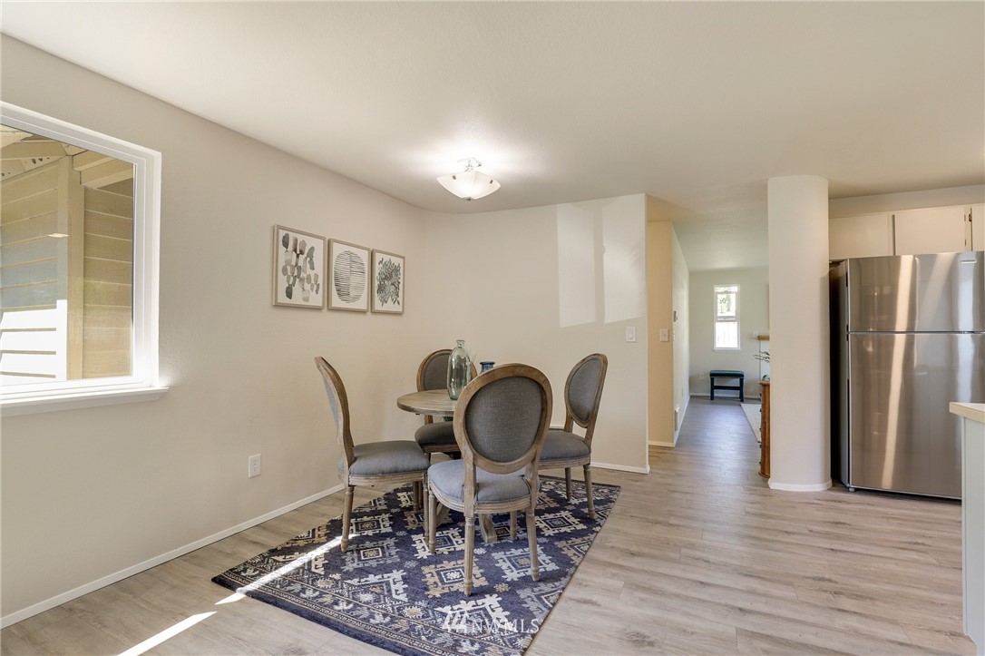 1017 234th Place Southwest Bothell, WA 98021 - Photo 15 of 28 a dining room with furniture a rug and wooden floor