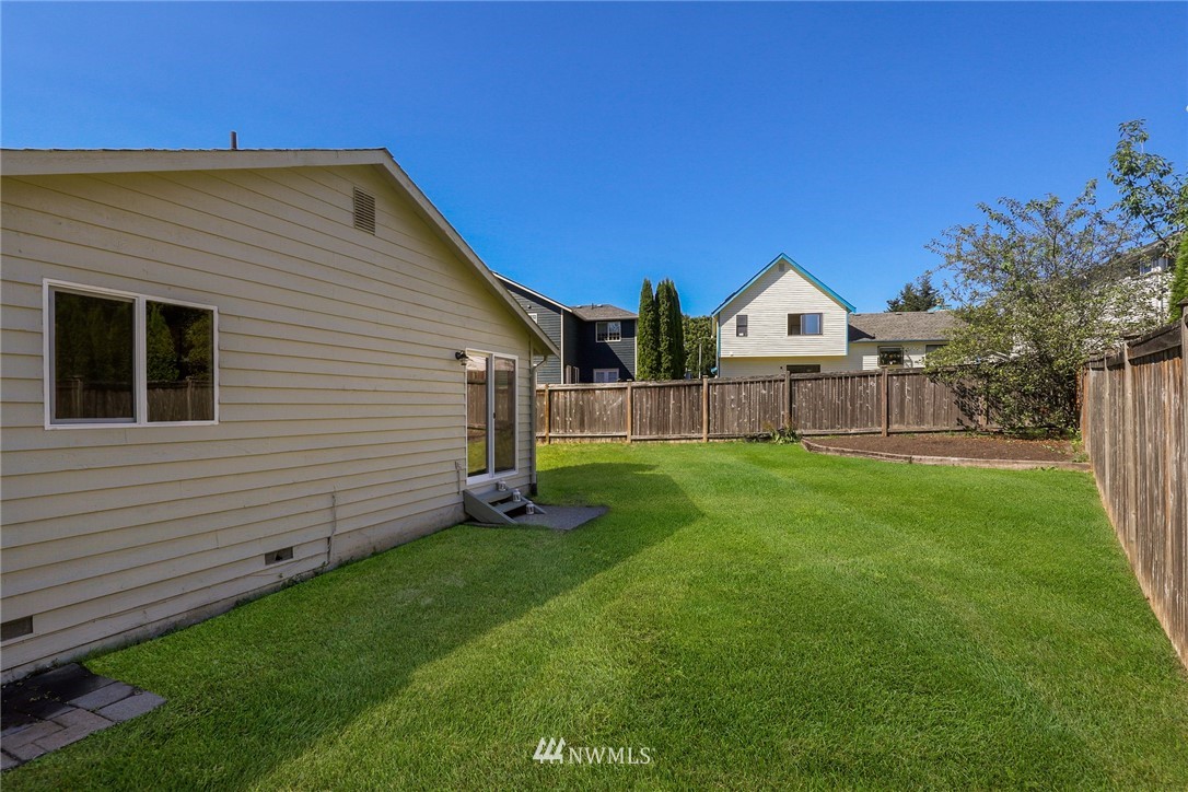 1017 234th Place Southwest Bothell, WA 98021 - Photo 25 of 28 a front view of a house with a yard