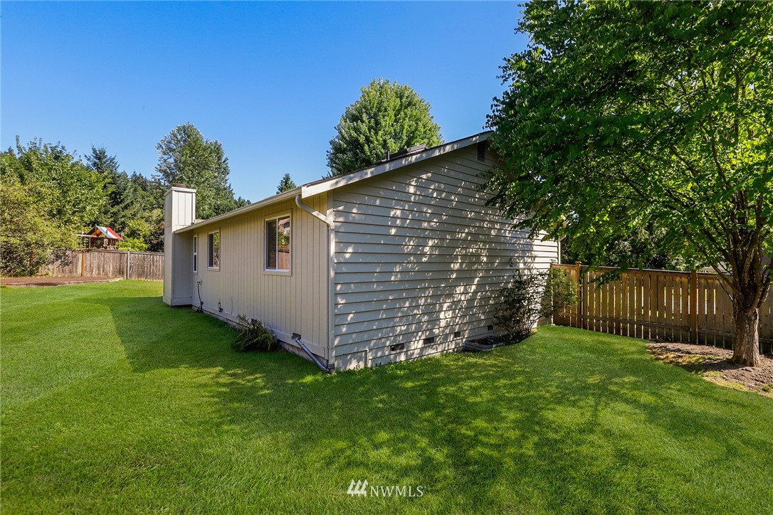 1017 234th Place Southwest Bothell, WA 98021 - Photo 26 of 28 a view of a backyard with a plants and large tree