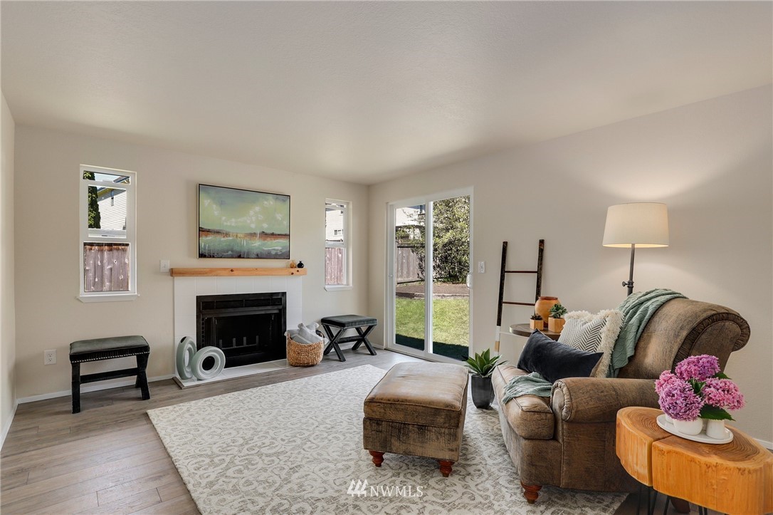 1017 234th Place Southwest Bothell, WA 98021 - Photo 5 of 28 a living room with furniture and a fireplace
