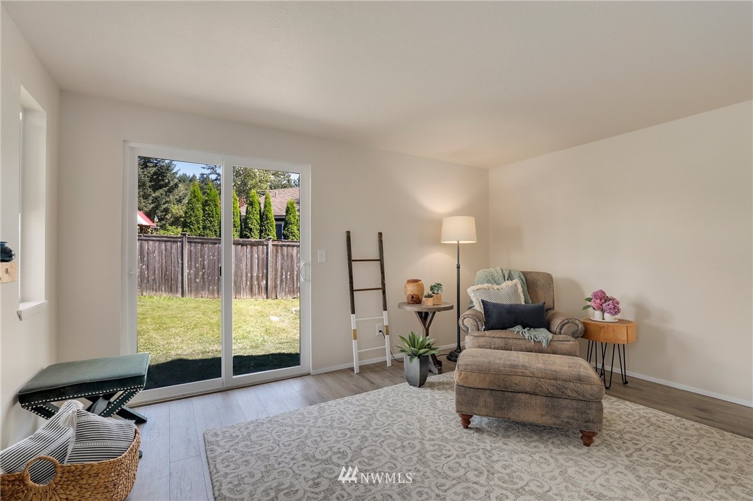 1017 234th Place Southwest Bothell, WA 98021 - Photo 6 of 28 a living room with furniture and a large window