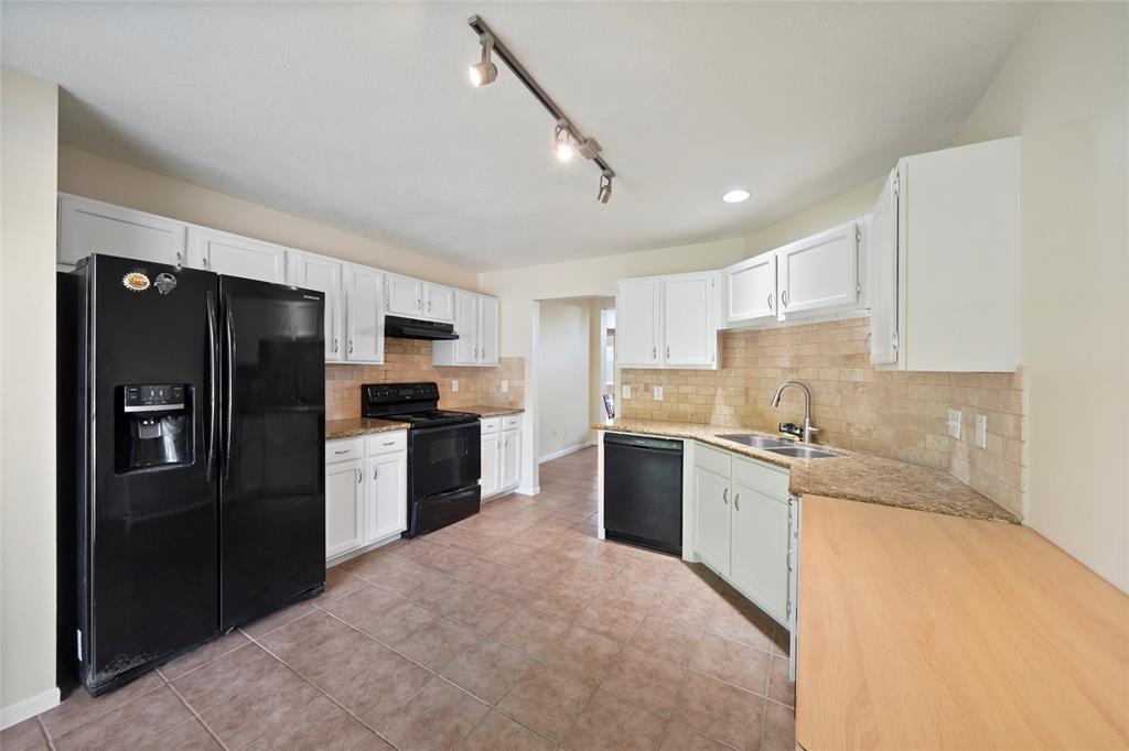 a large kitchen with cabinets stainless steel appliances and a counter space
