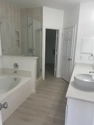 a bathroom with a sink a bathtub and a shower