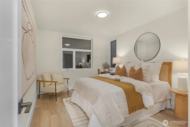 a bedroom with two beds and a large window