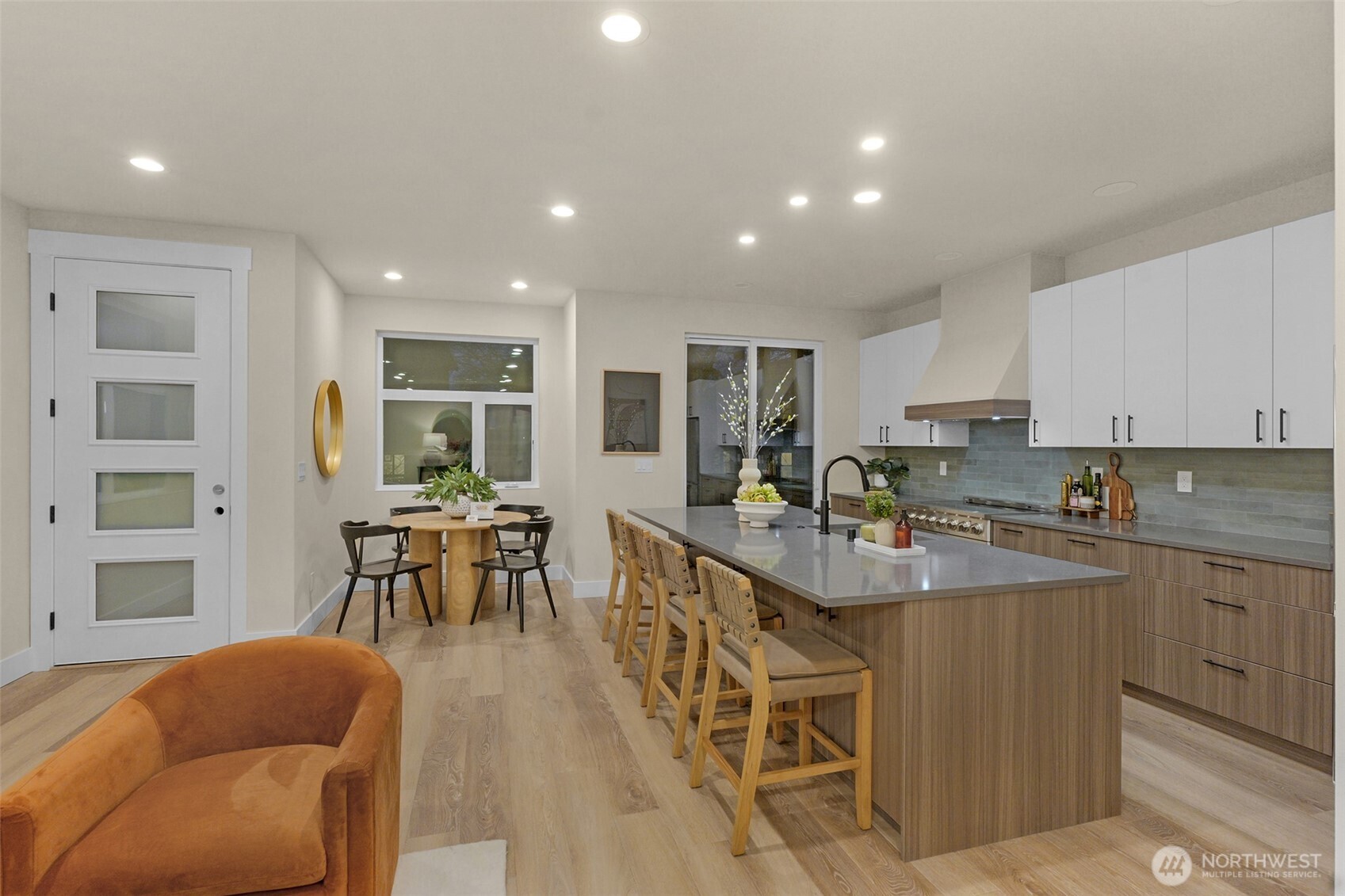 910 15th Avenue Seattle, WA 98122 - Photo 7 of 35 a kitchen with stainless steel appliances granite countertop a table chairs sink and cabinets