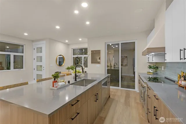 a kitchen with stainless steel appliances granite countertop white cabinets a sink and dishwasher