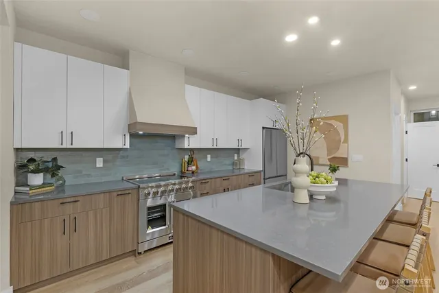 a kitchen with sink and mirror