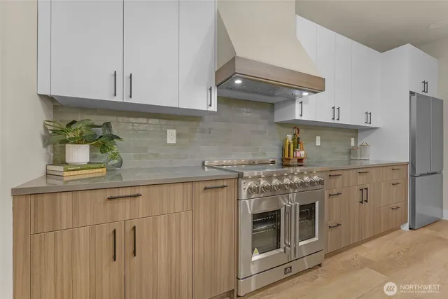 a living room with furniture and a refrigerator