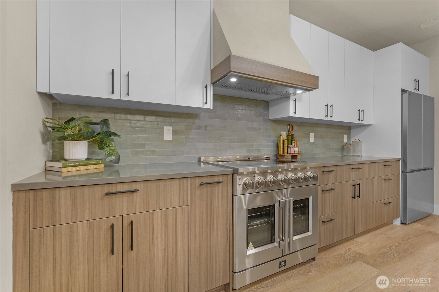 910 15th Avenue Seattle, WA 98122 - Photo 10 of 35 a kitchen with stainless steel appliances granite countertop white cabinets a sink and dishwasher