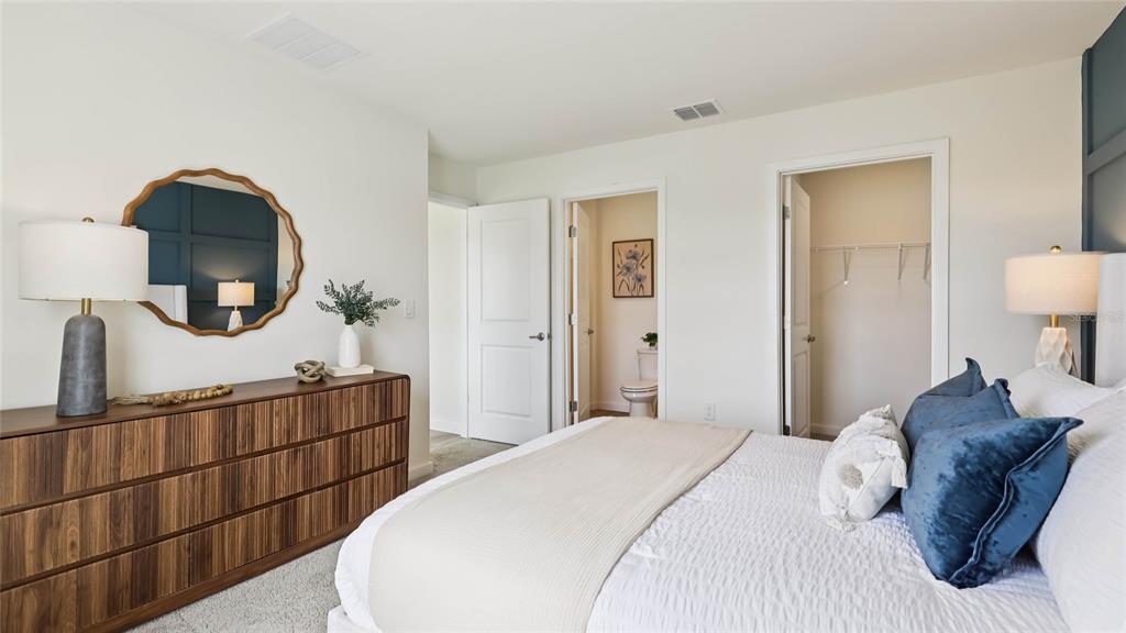 4694 Kona Circle Spring Hill, FL 34608 - Photo 17 of 29 a bedroom with a large bed and a mirror