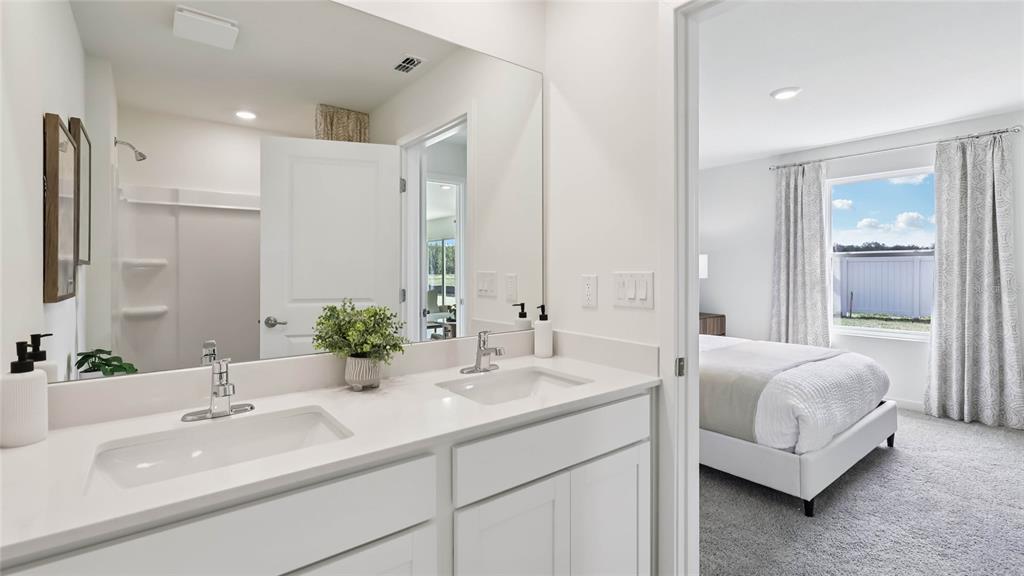 4694 Kona Circle Spring Hill, FL 34608 - Photo 18 of 29 a bathroom with a double vanity sink and a mirror