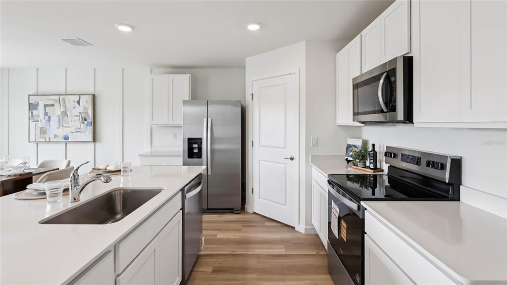 4694 Kona Circle Spring Hill, FL 34608 - Photo 4 of 29 a kitchen with stainless steel appliances a sink stove and refrigerator