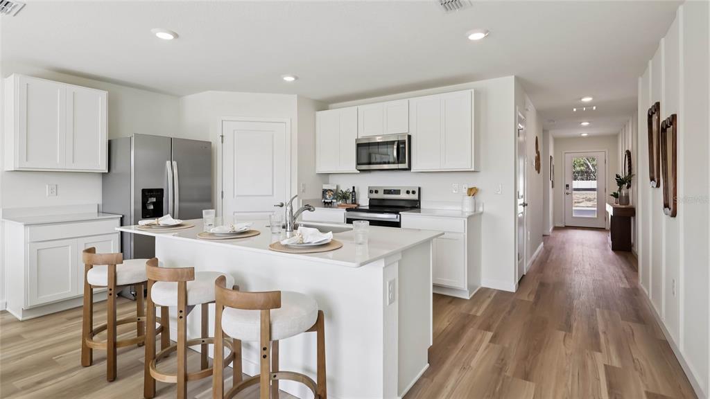 4694 Kona Circle Spring Hill, FL 34608 - Photo 5 of 29 a kitchen with appliances a sink a counter top space and cabinets