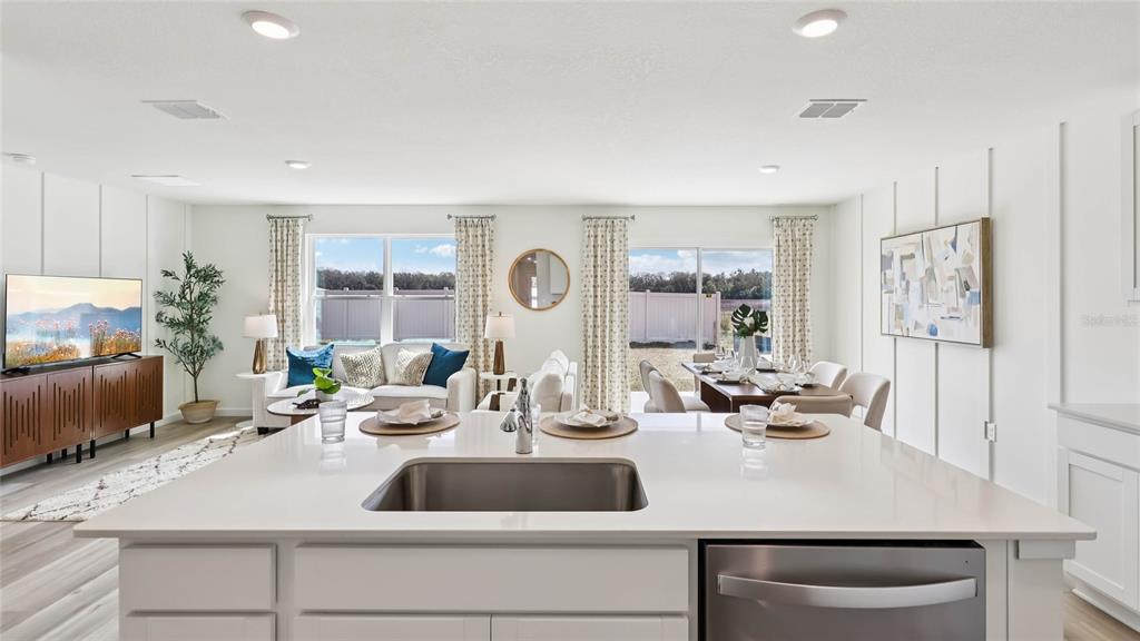 4694 Kona Circle Spring Hill, FL 34608 - Photo 6 of 29 a kitchen with a sink a counter top space and living room area