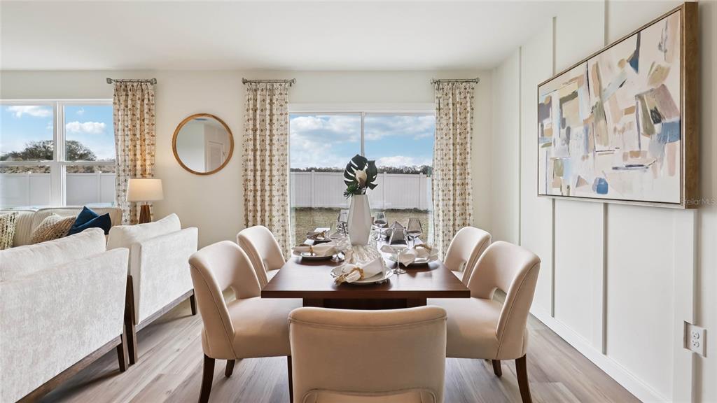 4694 Kona Circle Spring Hill, FL 34608 - Photo 10 of 29 a dining room with furniture a window and wooden floor