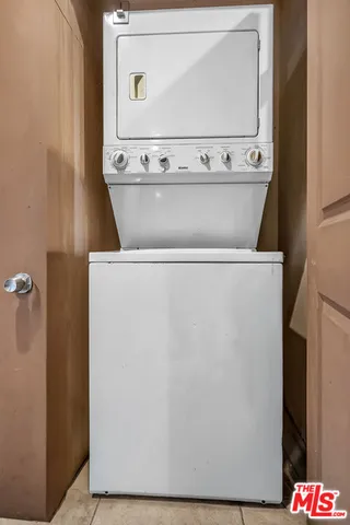 a view of a white house with a yard and plants
