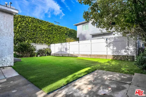 a view of a backyard with large trees