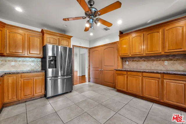 a kitchen with stainless steel appliances granite countertop a refrigerator and cabinets